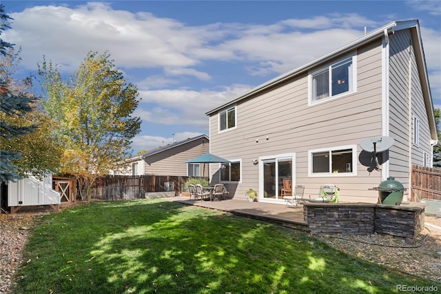 rear view of property featuring a patio and a lawn