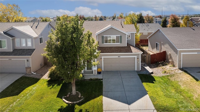 view of front of house featuring a front yard and a garage