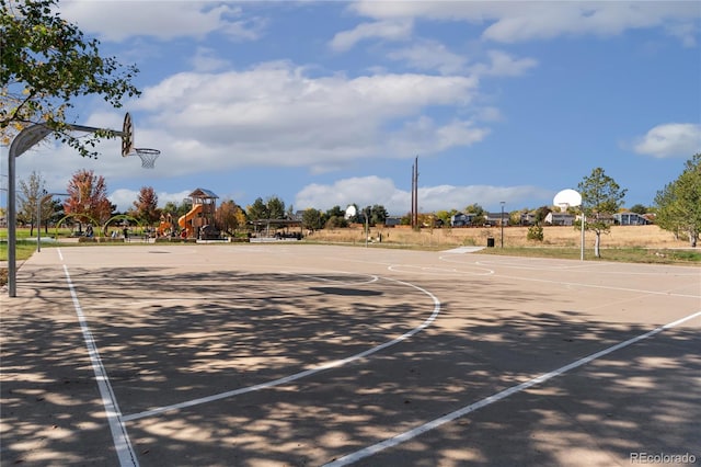 view of basketball court featuring a playground