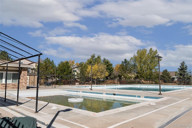 view of swimming pool with a patio area