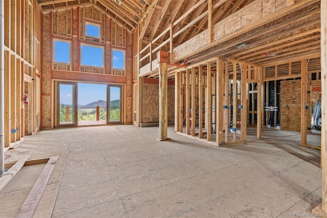 miscellaneous room featuring a mountain view and a high ceiling