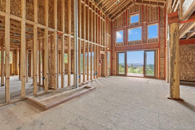 miscellaneous room with a mountain view and a high ceiling