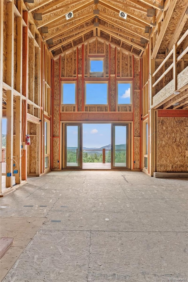 miscellaneous room with a mountain view and a high ceiling