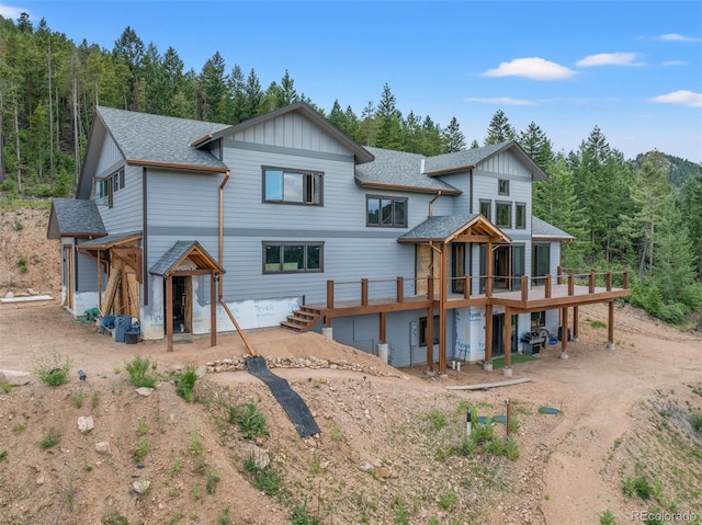 rear view of property with a wooden deck