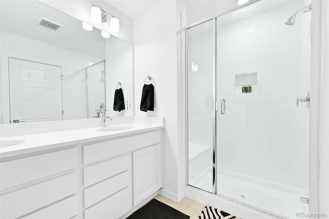 5387 Pierson Ct, Wheat Ridge, CO 80033 - full bathroom featuring a shower stall, double vanity, tile patterned floors, and baseboards