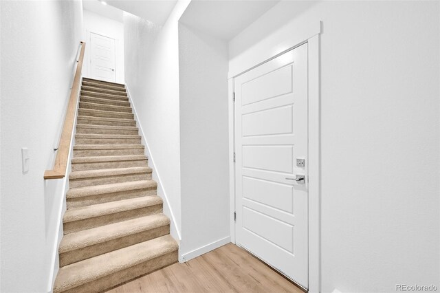 5387 Pierson Ct, Wheat Ridge, CO 80033 - stairs featuring wood finished floors and baseboards
