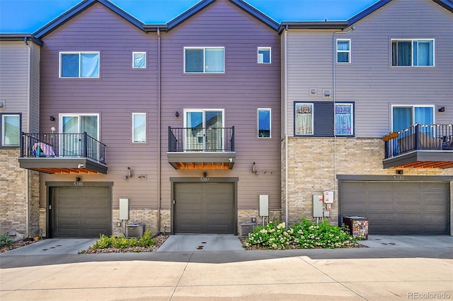 5387 Pierson Ct, Wheat Ridge, CO 80033 - back of house featuring an attached garage and central AC unit