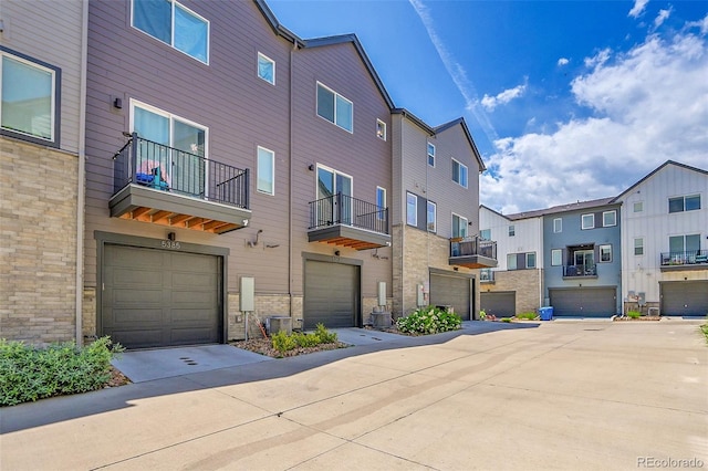 5387 Pierson Ct, Wheat Ridge, CO 80033 - view of property featuring a garage, driveway, and a residential view
