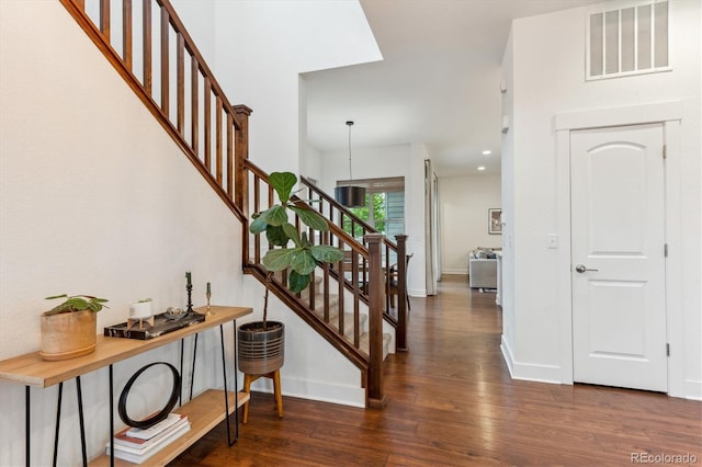 staircase with wood finished floors and baseboards