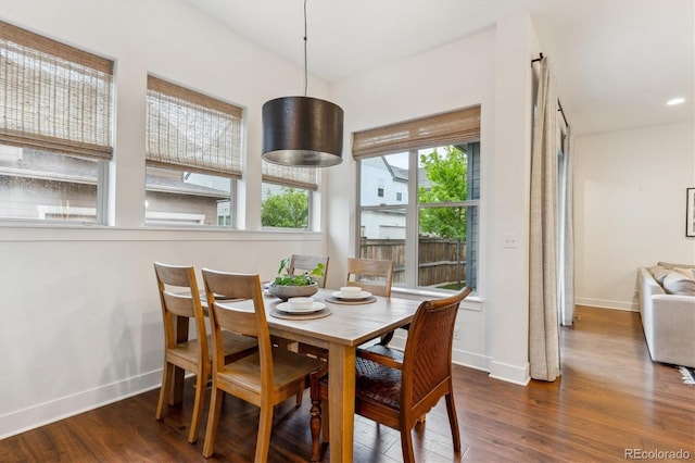 dining area with baseboards and wood finished floors