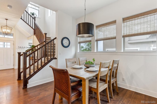 dining room with stairway, baseboards, and dark wood-style flooring
