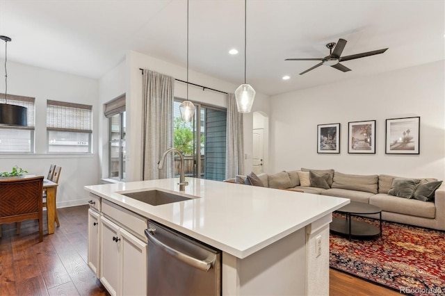 kitchen featuring a sink, stainless steel dishwasher, open floor plan, dark wood-type flooring, and recessed lighting