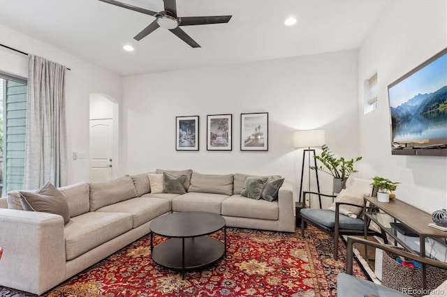 living area featuring a ceiling fan, arched walkways, and recessed lighting
