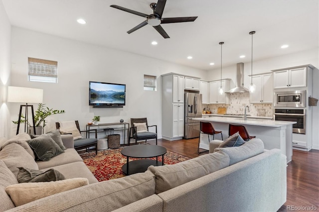 living area with a ceiling fan, dark wood-style floors, recessed lighting, and baseboards