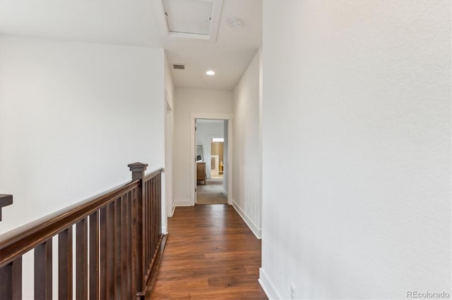 hall featuring dark wood finished floors, recessed lighting, an upstairs landing, attic access, and baseboards