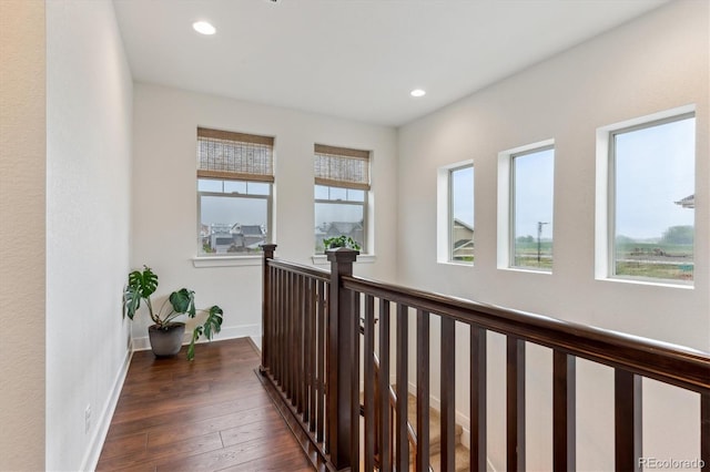 hall featuring dark wood finished floors, recessed lighting, and baseboards