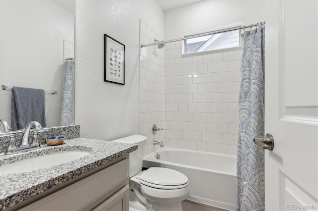 bathroom featuring toilet, shower / tub combo, and vanity