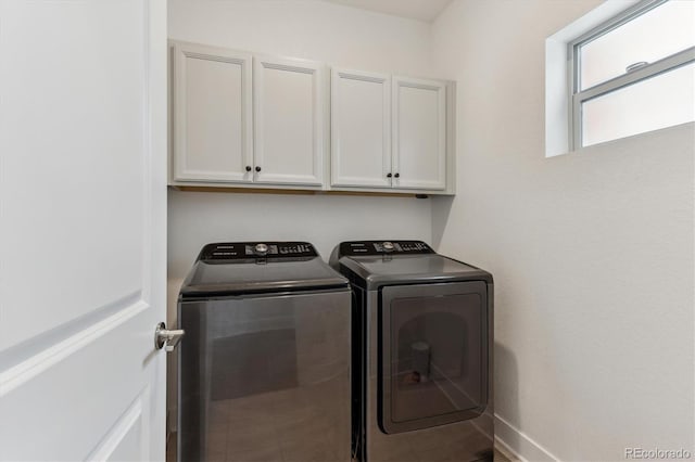 laundry area featuring cabinet space, washer and dryer, and baseboards