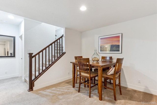 dining area with light carpet, baseboards, and recessed lighting