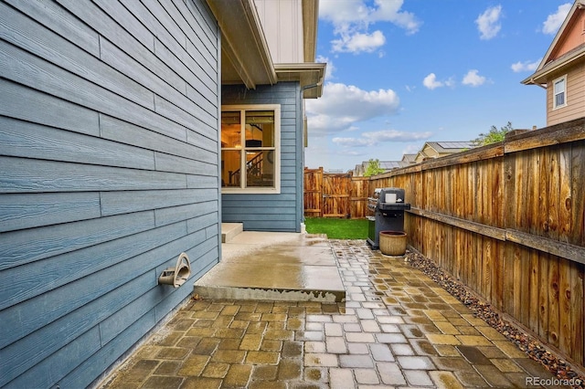 view of side of property with a fenced backyard and a patio area