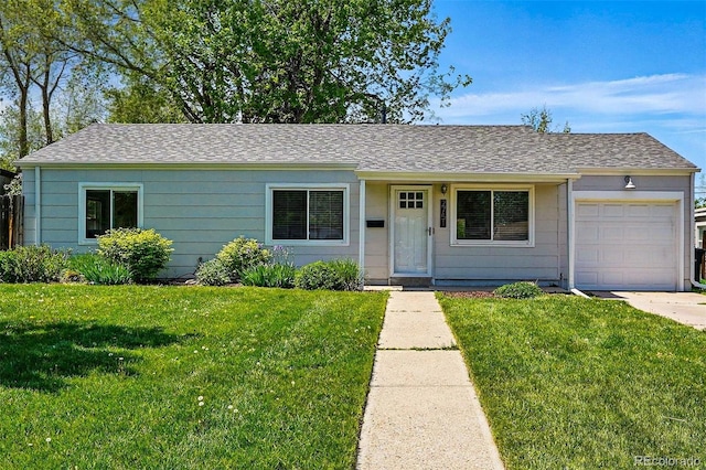 ranch-style home with a garage, a front lawn, roof with shingles, and driveway