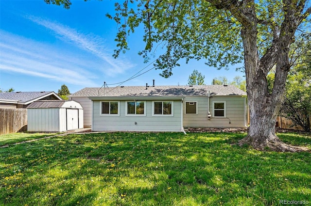 rear view of property with a shed and an outbuilding