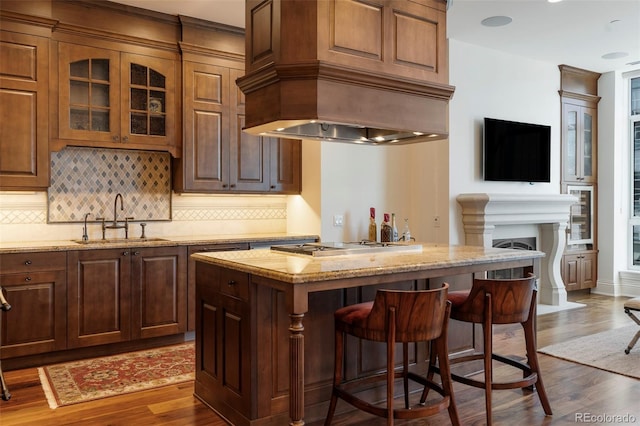 bar with light stone countertops, dark hardwood / wood-style flooring, sink, wine cooler, and stainless steel gas stovetop