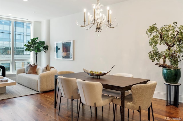 dining room featuring a chandelier, expansive windows, and wood-type flooring