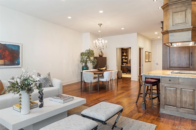 living room with dark hardwood / wood-style flooring and a notable chandelier