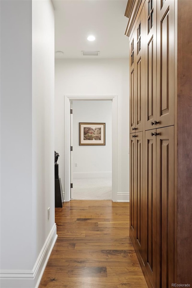 corridor featuring dark wood-type flooring