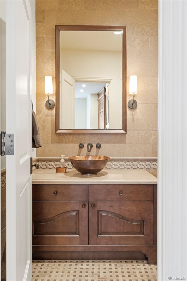 bathroom featuring tasteful backsplash, vanity, and tile walls