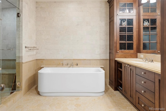 bathroom featuring tile patterned flooring, vanity, and independent shower and bath