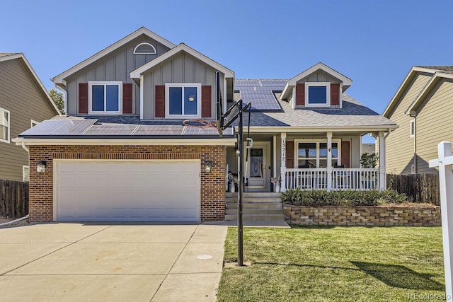 view of front facade with concrete driveway, a porch, board and batten siding, and brick siding