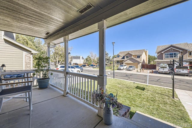 view of patio with covered porch, a residential view, and visible vents