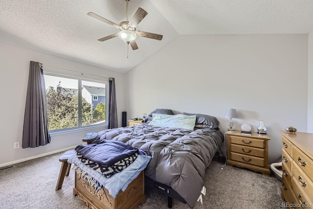 bedroom featuring vaulted ceiling, a textured ceiling, carpet flooring, and a ceiling fan