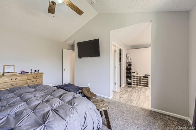 carpeted bedroom with lofted ceiling, ceiling fan, a textured ceiling, and baseboards