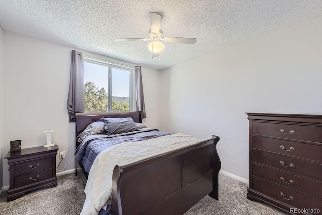 carpeted bedroom featuring a ceiling fan, a textured ceiling, and baseboards