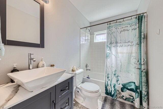 full bathroom with shower / tub combo, vanity, and toilet