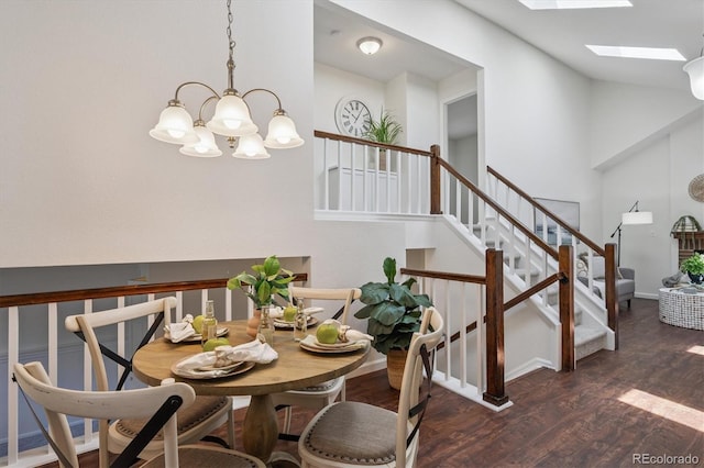 9194 Hickory Cir, Highlands Ranch, CO 80126 - dining space featuring a chandelier, wood finished floors, vaulted ceiling, stairs, and a skylight