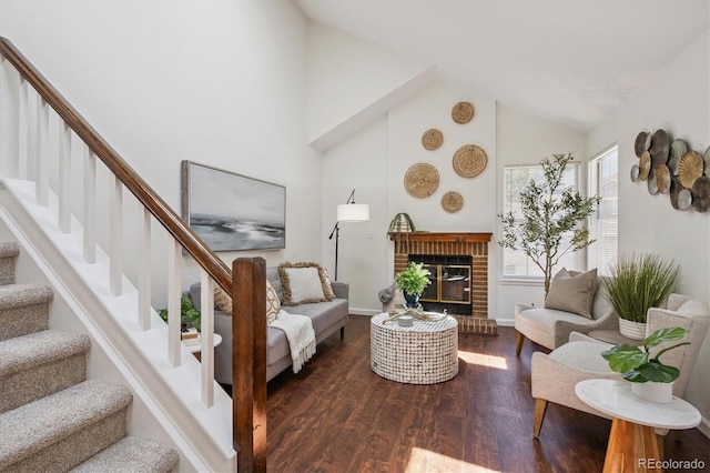 9194 Hickory Cir, Highlands Ranch, CO 80126 - living area with wood finished floors, stairway, high vaulted ceiling, and a brick fireplace