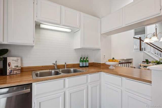 9194 Hickory Cir, Highlands Ranch, CO 80126 - kitchen with dishwasher, decorative backsplash, white cabinets, and a chandelier