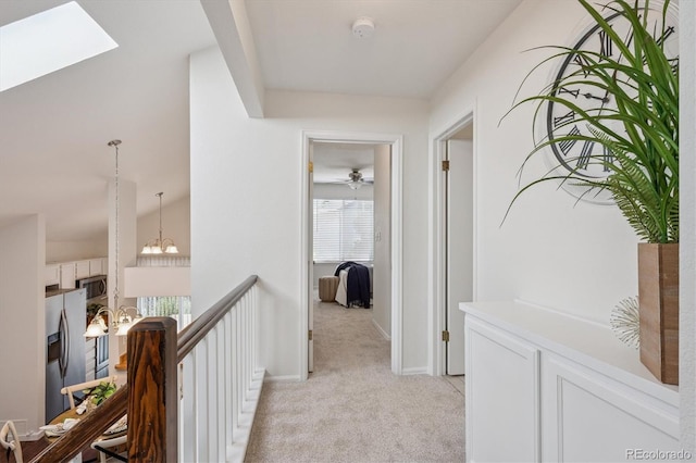 9194 Hickory Cir, Highlands Ranch, CO 80126 - corridor with light carpet, an upstairs landing, and a chandelier