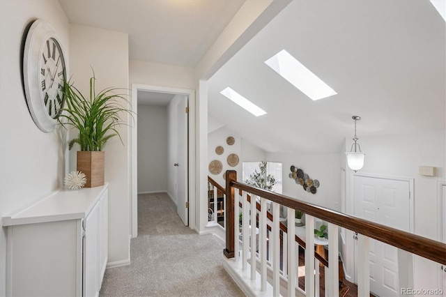 9194 Hickory Cir, Highlands Ranch, CO 80126 - hallway featuring a skylight, an upstairs landing, light carpet, and vaulted ceiling