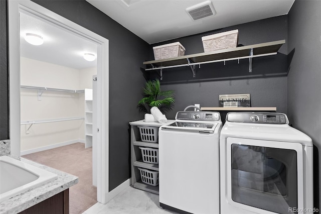 laundry area featuring washing machine and dryer, laundry area, baseboards, and visible vents