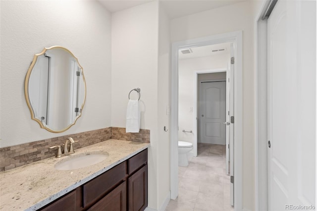 bathroom featuring visible vents, vanity, tasteful backsplash, and toilet