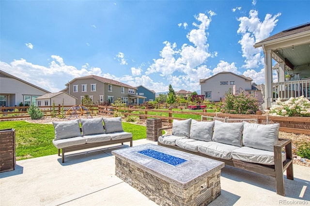 view of patio with an outdoor living space with a fire pit and a residential view