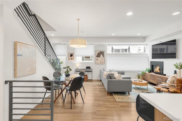 1238 Quitman St Unit 2, Denver, CO 80204 - living area featuring stairs, light wood-style flooring, a glass covered fireplace, and recessed lighting