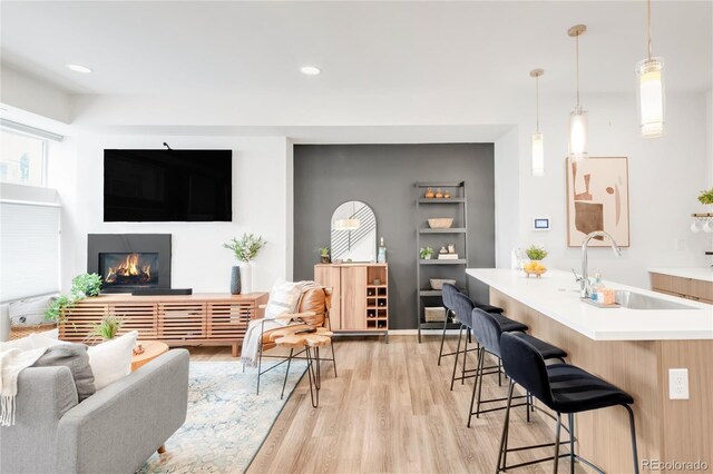1238 Quitman St Unit 2, Denver, CO 80204 - living area with light wood-style flooring, a glass covered fireplace, and recessed lighting