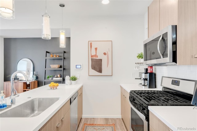 1238 Quitman St Unit 2, Denver, CO 80204 - kitchen with stainless steel appliances, modern cabinets, light brown cabinetry, and light wood-style flooring