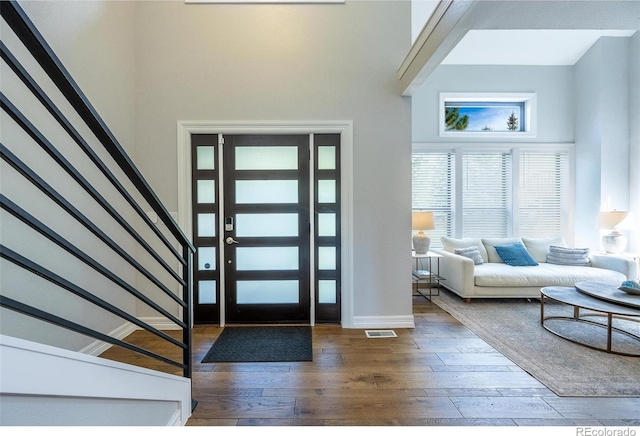 entrance foyer featuring a high ceiling and hardwood / wood-style floors